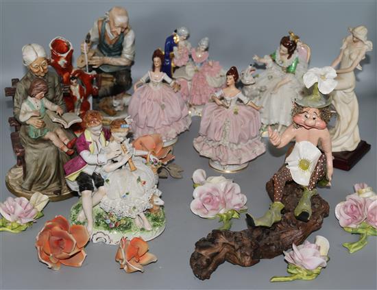 A group of ceramic figures and ceramic flower pieces